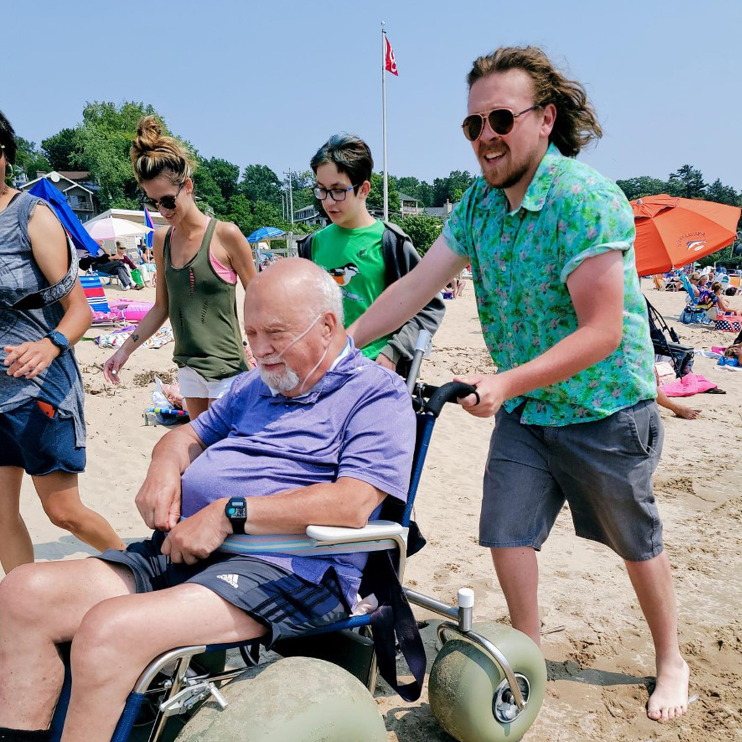 senior man and therapist at beach